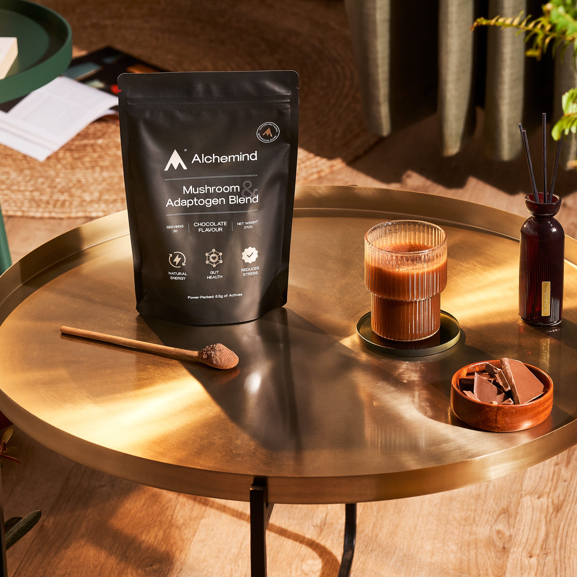 Bag standing on a coffee table with a glass of chocolate next to it